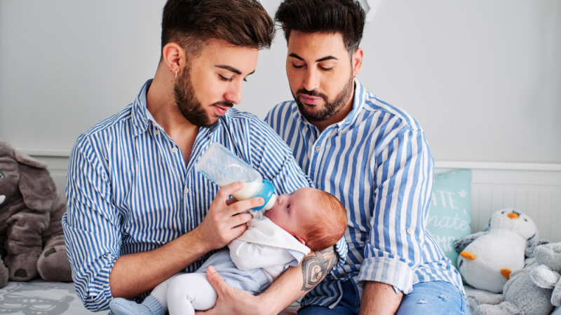 Gay couple formula feed their baby