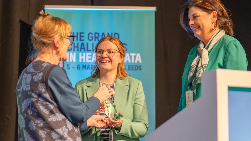 Jan Speechley,Chair of the Panel and member of HDR UK Public Advisory Board, presenting the Public and Patient Involvement and Engagement Award to winners representing Understanding Patient Data